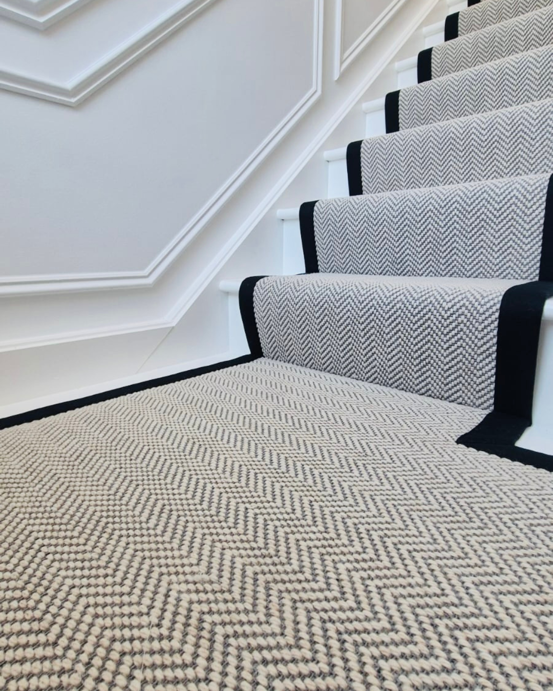 Herringbone stair runner with a contrasting black border