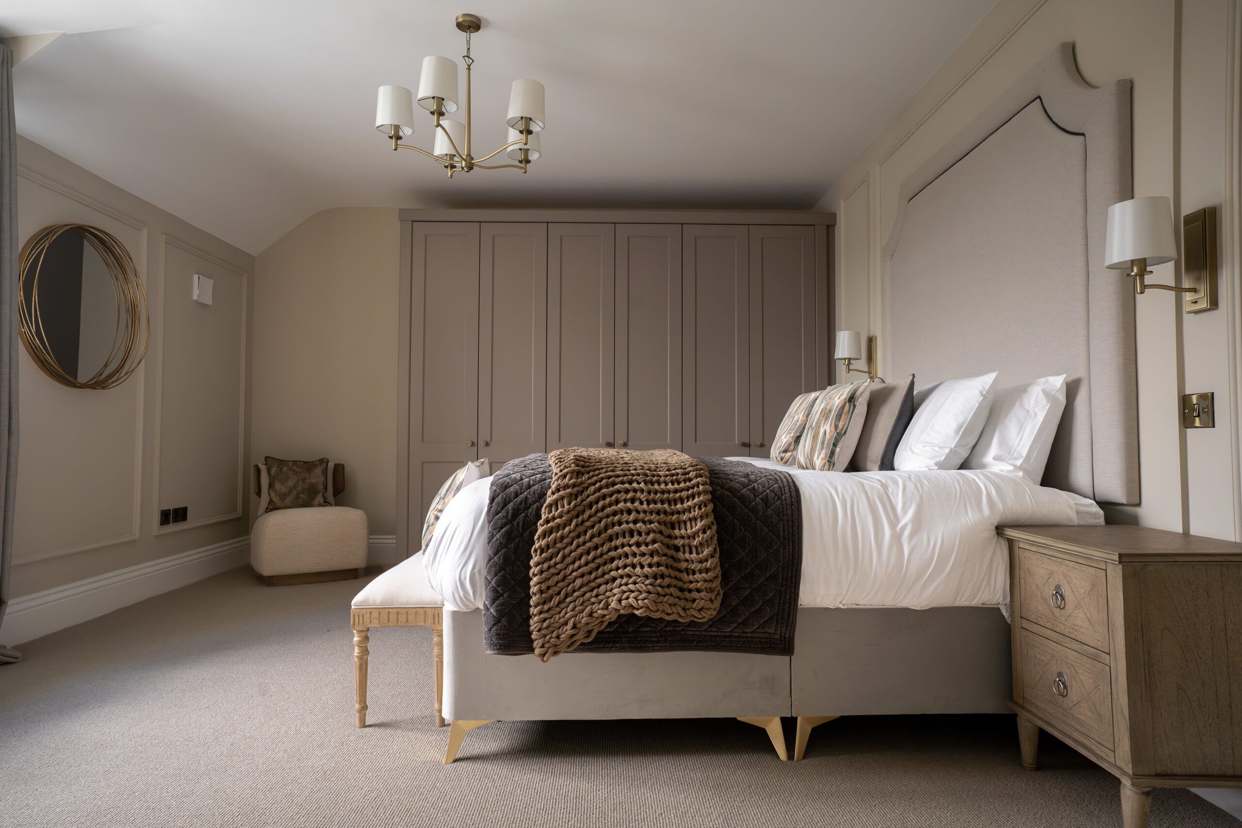 Soft neutral bedroom carpet beneath an upholstered bed in a warm contemporary interior