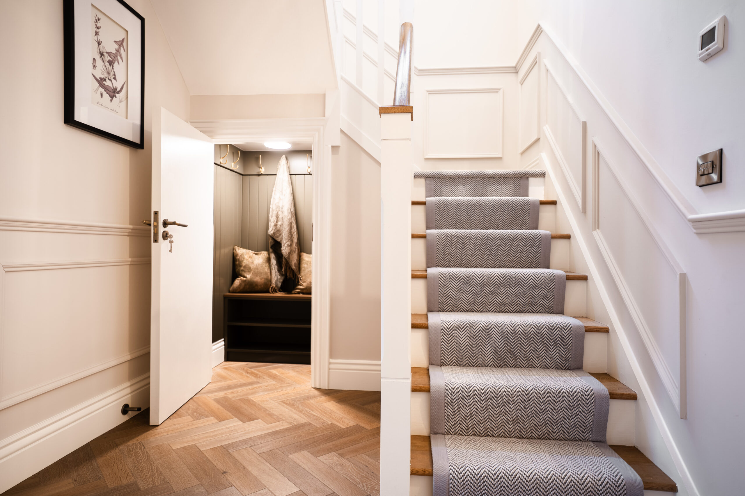 Patterned stair runner with contrasting edging on a timber staircase