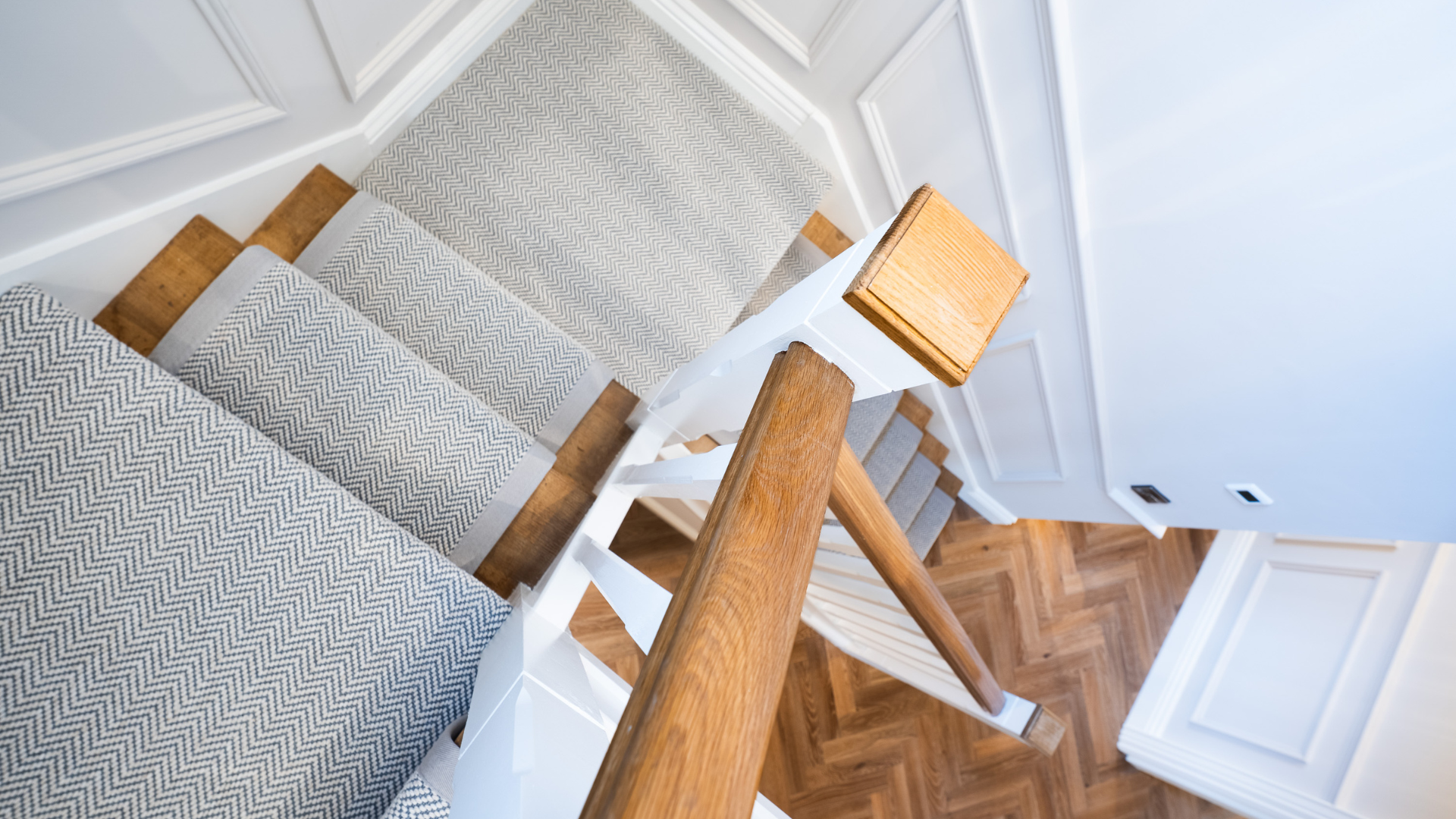 Herringbone stair runner with grey borders on a timber staircase viewed from above